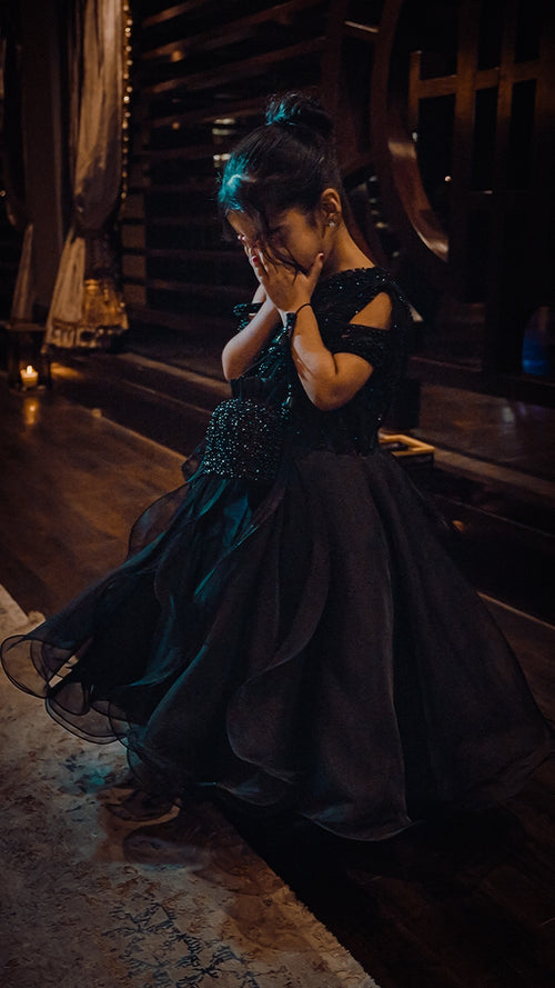 Celeste black occasion gown with beaded bodice and full ruffled organza skirt