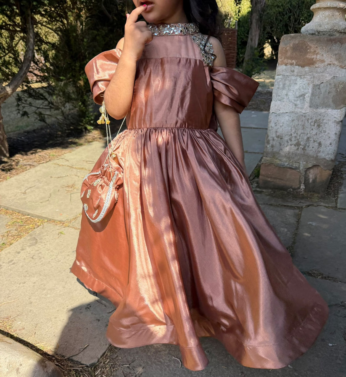 Rosalie gown front view beside a garden balustrade; styling pouch not included