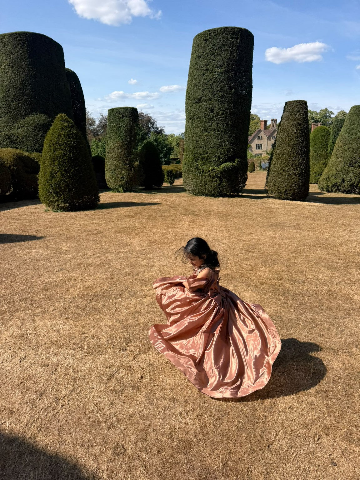 Rosalie gown in motion, with the full skirt spreading across the garden