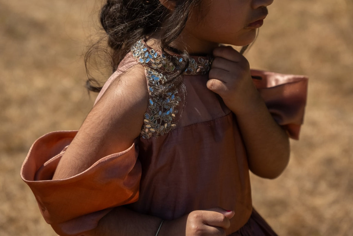 Rosalie rose-gold gown: embellished neckline and draped sleeve close-up