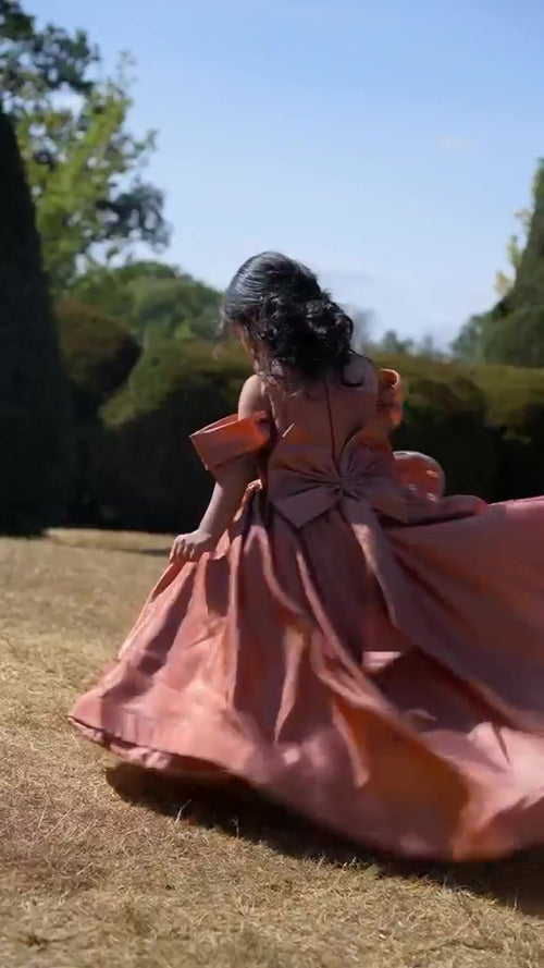 Rosalie rose-gold gown showing the detachable bow and full skirt