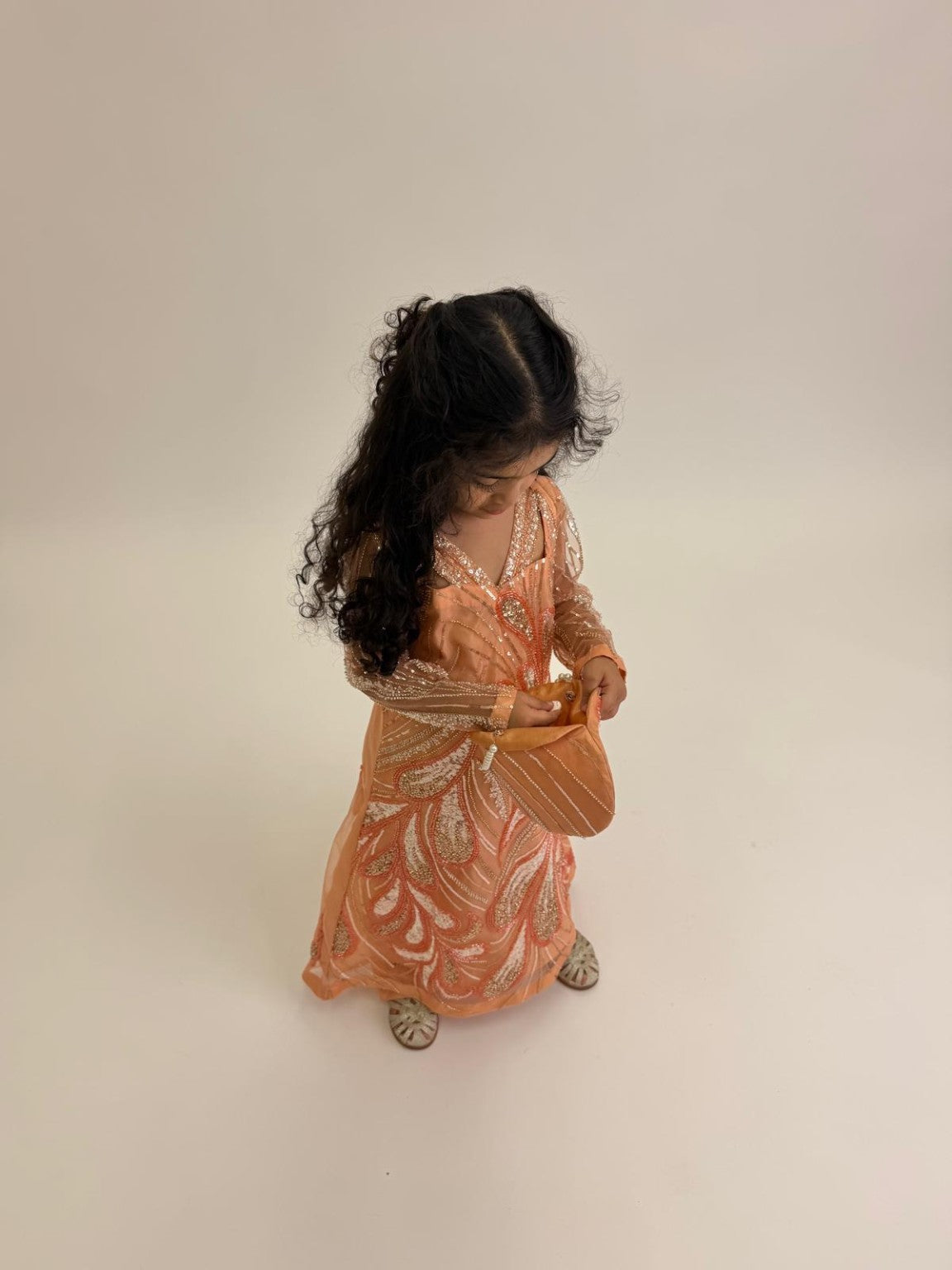Zaria peach occasion dress in a full-length campaign photograph