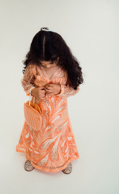 Zaria peach occasion dress, full-length front view showing shimmering embroidered detailing and sheer embellished sleeves